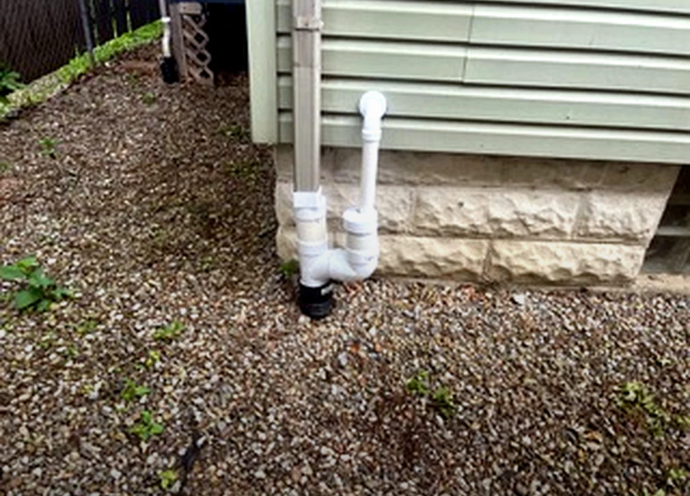 Discharge line routing outside the home by Sferra Waterproofing