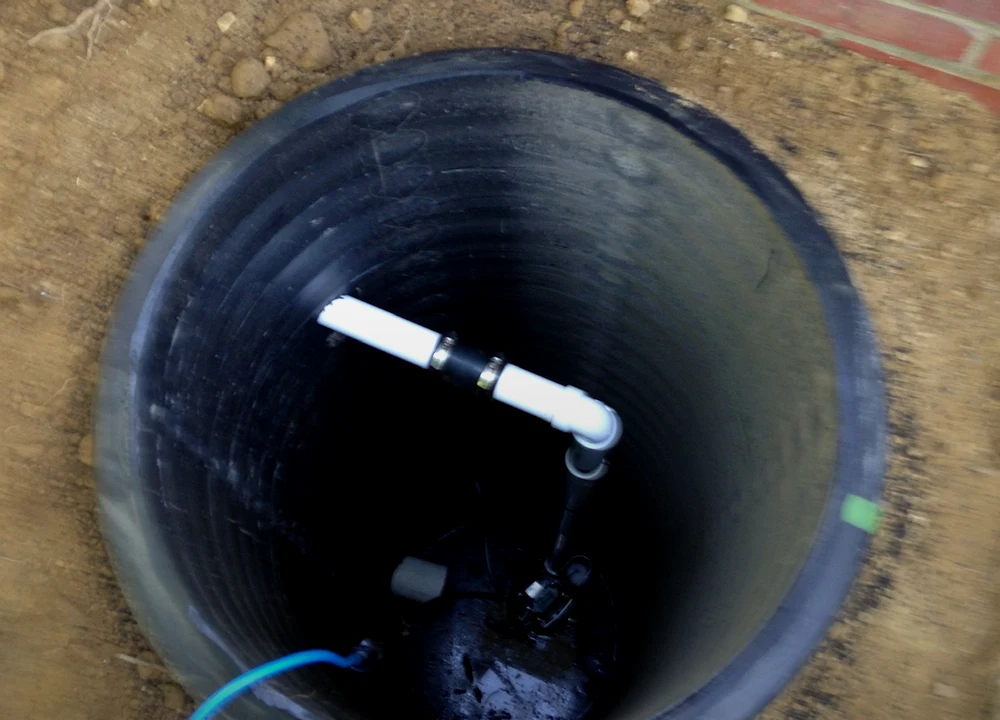 Sump pump basin and drainage connection by Sferra Waterproofing